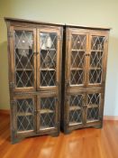 A pair of reproduction oak and leaded glass door bookcases,