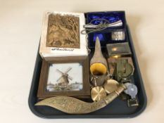 Three compasses, an Acme kazoo, an Indian enameled brass kukri, a Balkan Palamarka harvesting tool,