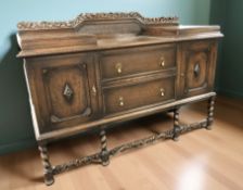 An early 20th century carved oak sunk centre buffet sideboard,