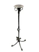 A wrought metal candle stand,