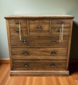 A late Victorian oak chest fitted seven drawers around a central hat drawer,