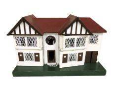 A mid-20th century Tri-Ang doll's house containing various furniture, width 66 cm.