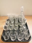 A collection of crystal drinking glasses, decanter.