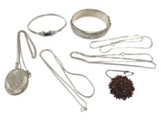 A group of silver jewellery including chains, locket on chain,