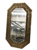 An embossed brass octagonal mirror,