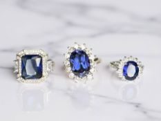 Three silver synthetic sapphire dress rings.