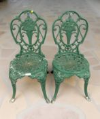 A pair of cast and painted aluminium garden chairs