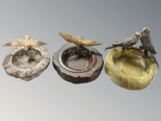 An onyx ashtray surmounted by two cold-painted metal budgies, width 13 cm,