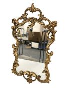 A reproduction gilt composition mirror,