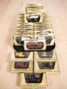 A collection of Matchbox Models of Yesteryear boxed die cast delivery vans, classic cars, etc.