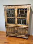 An oak Jaycee linen fold and leaded glass bookcase,
