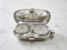 A silver double sovereign case,