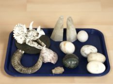 A replica triceratops skull, polished marble eggs, pair of alabaster bookends in the form of birds,