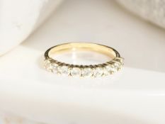 A 9ct gold Ceylon white sapphire half-eternity ring, size T CONDITION REPORT: 1.