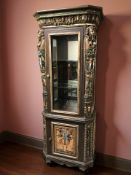 A highly decorative Egyptian style glazed single door display cabinet with illuminated interior,