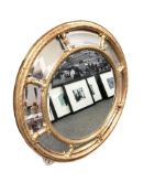 A reproduction gilt circular mirror,