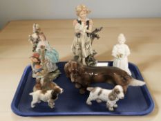 A group of figures including Capodimonte figure of a lady reading, Goebel figure,