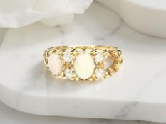 A yellow gold diamond and opal ring, size I/J. CONDITION REPORT: 2.7g.