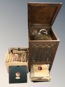An early 20th century oak cased gramophone and a quantity of 78 records.
