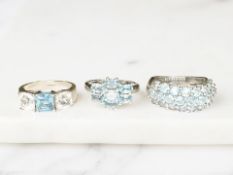Three silver blue topaz dress rings.