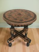 A small round hand painted collapsible Romany table,