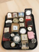 A collection of travel timepieces, compass, etc.