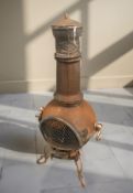 A cast iron pot bellied chiminea, height 115 cm.