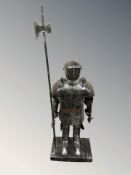 A contemporary metal figure of a knight with halberd, height 142 cm.