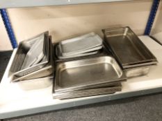A quantity of stainless steel catering dishes