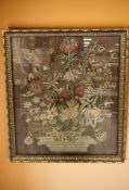 An antique needlework panel in gilt frame,