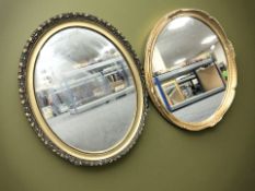 Two reproduction gilt oval mirrors,