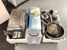 A quantity stainless steel cooking pans, colanders,