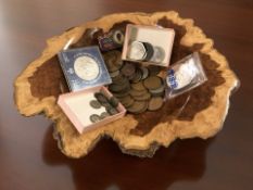 A polished burr wood bowl containing assorted British coins, some pre-1947 silver pieces, crowns,