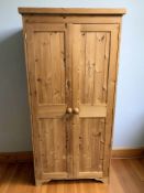 A modern pine double wardrobe,