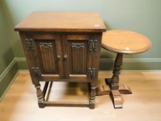 A reproduction oak double door cabinet, width 50 cm together with lamp table,