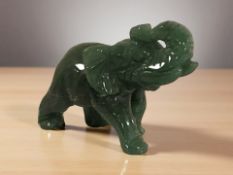 A carved and polished jadeite figure of an elephant, length 6.5 cm.