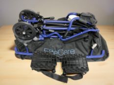A folding wheelchair in carry bag.