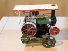 A Mamod steam tractor and a further live steam pistol engine component.