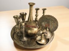 An ornate eastern engraved brass charger, diameter 49 cm, an Indian enameled brass peacock,