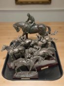 A group of contemporary bronzed figures of famous jockeys on horseback.