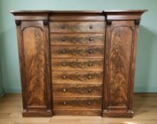 A Victorian mahogany inverted-breakfront compactum wardrobe fitted with a pair of cabinets with