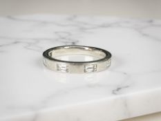 A platinum baguette-cut diamond half-eternity ring, approximately 0.