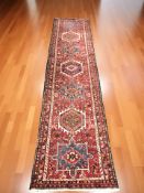 A Heriz runner, 394 cm x 92 cm.