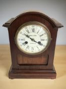 An Edwardian stained beech mantel clock, striking on a gong, with pendulum,