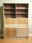 A 20th century Danish open bookcase, fitted cupboards and drawers beneath, 139 cm x 43 cm x 196 cm.