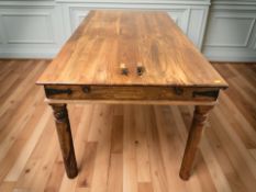 A sheesham wood dining table, 180 cm x 90 cm x 77 cm.