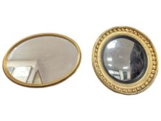 A late 19th century gilt convex circular mirror, diameter 57 cm,