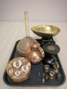 Two sets of graduated weights, a pan scale, copper jug and a poss stick.