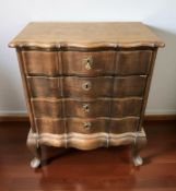 A continental oak serpentine front four drawer chest on pad feet, 65 cm x 37 cm x 77 cm.