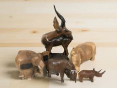 A group of carved wooden African animals